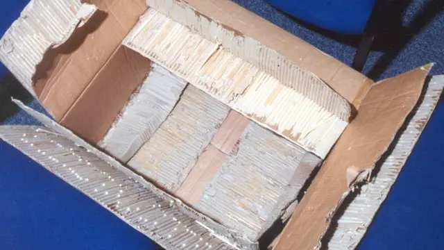 Hundreds of white straws filled with crack cocaine in a cardboard box.