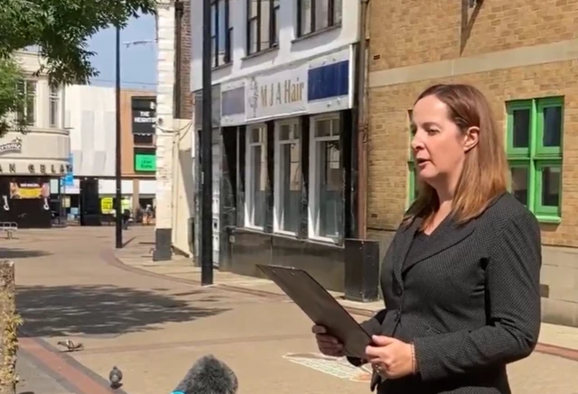 Celia Mardon speaks outside Luton Crown Court. She has short brown hair and wears a black suit.