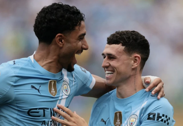 Manchester City's Phil Foden celebrates scoring their first goal with Omar Marmoush