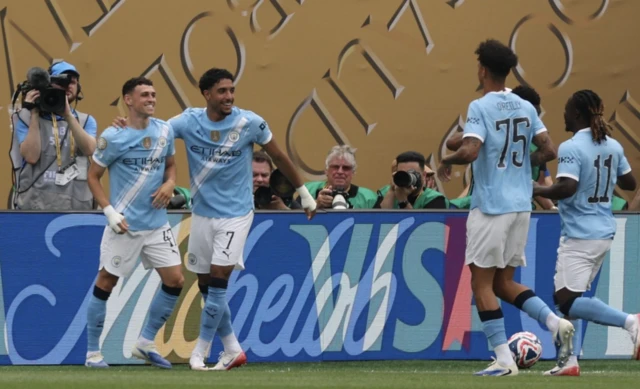 Manchester City's Phil Foden celebrates scoring their first goal with Omar Marmoush