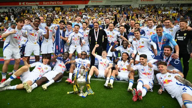 Players of Leeds United pose for a photo with the Sky Bet Championship trophy