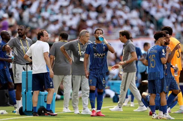 Renan Lodi of Al Hilal takes a hydration break