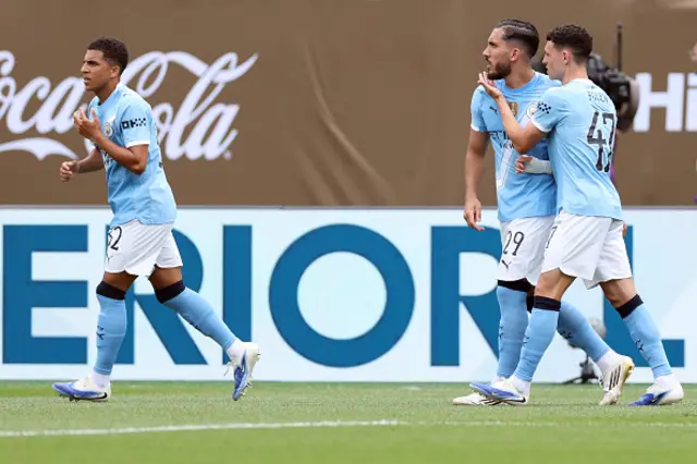 Phil Foden (R) celebrates with Manchester City's French midfielder #29 Rayan Cherki