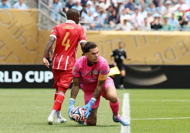 Ederson #31 of Manchester City makes a save in front of Thembinkosi Lorch