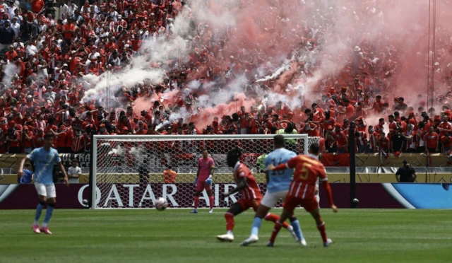 Wydad Casablanca fans with flares in the stands