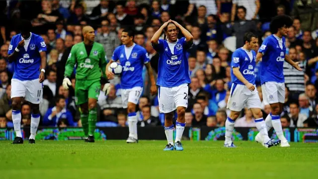 Steven Pienaar of Everton holds his head in his hands after his team concede a third goal to William Gallas of Arsenal
