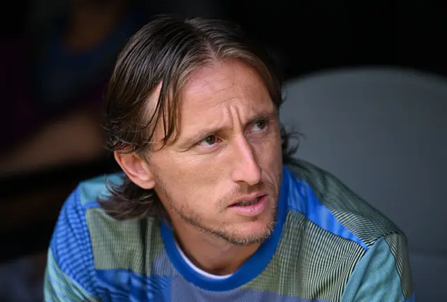 Luka Modric gestures on the bench