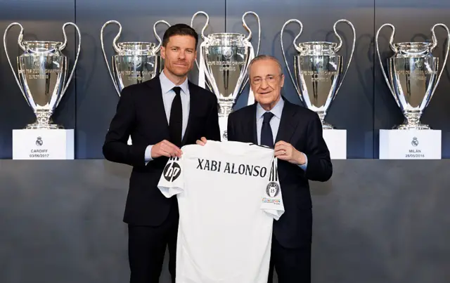 Xabi Alonso holding a Real Madrid shirt
