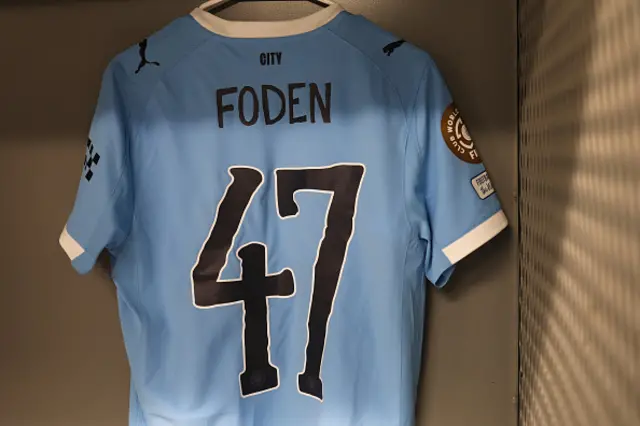 The shirt of Phil Foden #47 is displayed inside the Manchester City dressing room
