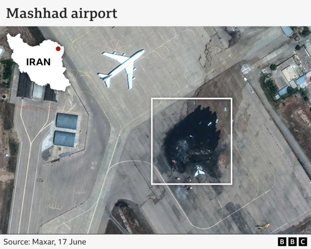 Graphic showing image of burnt-out Iranian air force jet at Mashhad Airport