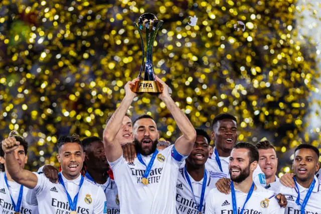 Karim Benzema lifting the Club World Cup for Real Madrid in 2022