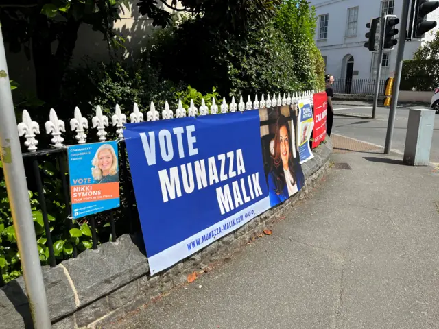 Several signs asking people for votes