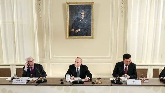 A pool photograph of Russian President Vladimir Putin at today's roundtable, distributed by Sputnik news agency.