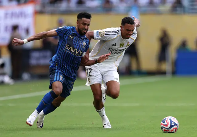 Trent Alexander-Arnold #12 of Real Madrid C.F. is challenged by Salem Aldawsari