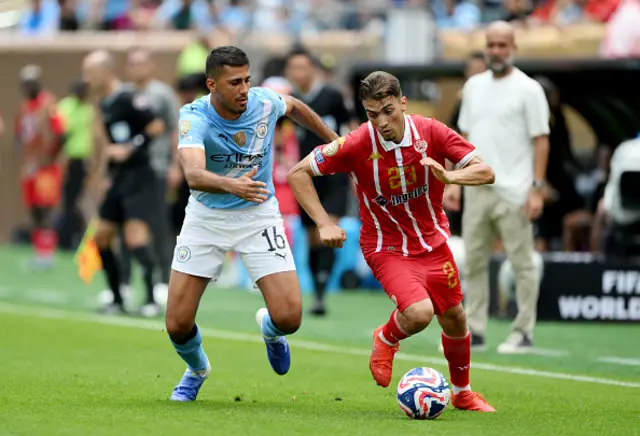 Oussama Zemraoui of Wydad AC is challenged by Rodri
