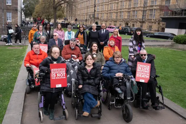MPs, Peers and Disability activists invited by Baroness Campbell, including actress Liz Carr and Dame Tanni Grey Thompson outside the Houses of Parliament.