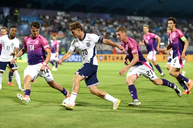 James Mcatee of England being followed by Elias Baum