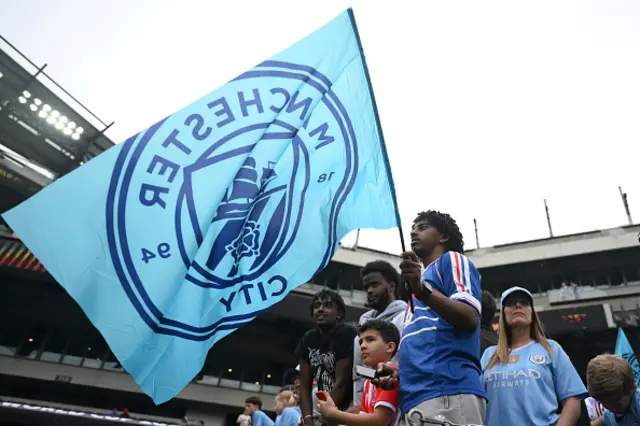 Fans of Manchester City look on