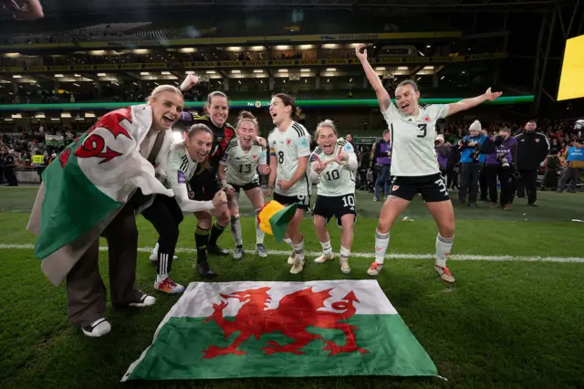 Wales players celebrate qualifying for Euro 2025