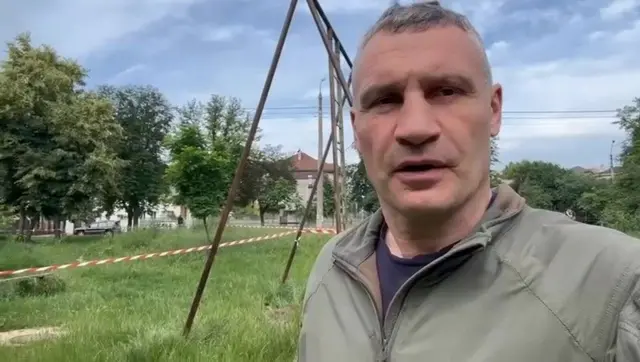 Vitali Klitchko standing in a playground in Kyiv. A swing set is visible in the background.