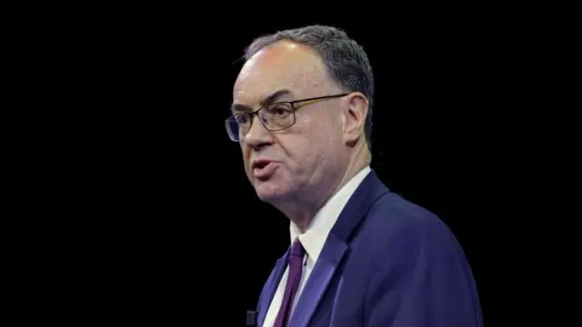 Andrew Bailey in suit and tie against a dark background