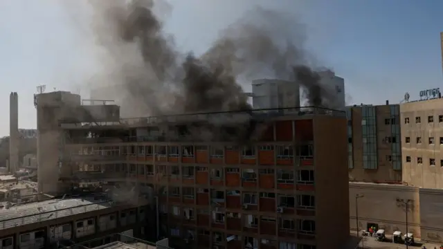 Smoke rising from damaged hospital.