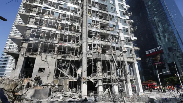 Emergency personnel work at an impact site following a strike from Iran on Israel, in Ramat Gan, Israel