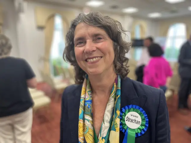 A woman in a blue suit with a Vote Strachan rosette