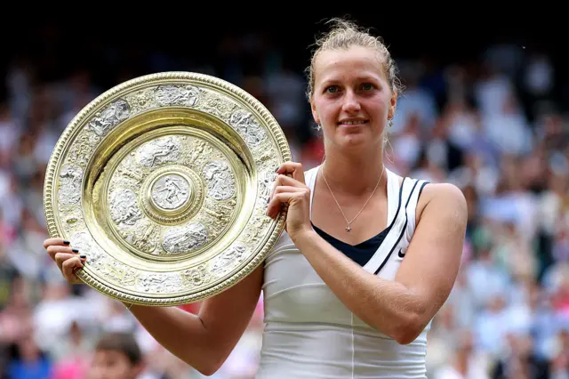 Petra Kvitova of the Czech Republic holds up the Championship trophy after winning her Ladies' final