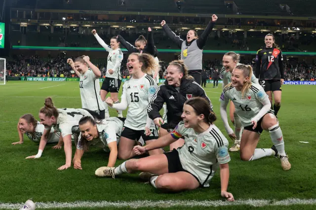 Wales players celebrate qualifying for Euro 2025
