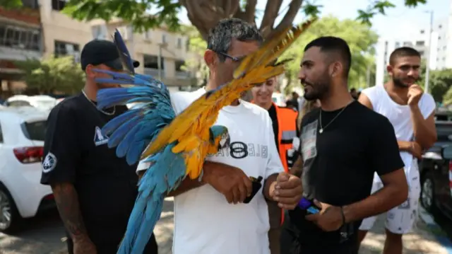 A man holding his parrot