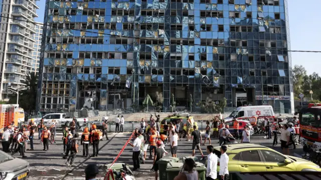 Emergency personnel work at an impact site following a strike from Iran on Israel, in Ramat Gan, Israel.