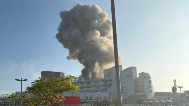 This image - taken from one video posted online earlier - shows a large smoke cloud in the background with the hospital buildings in front