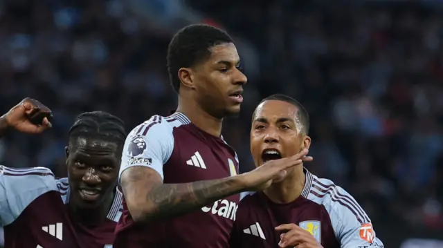 Marcus Rashford celebrates scoring a penalty for Aston Villa against Manchester City