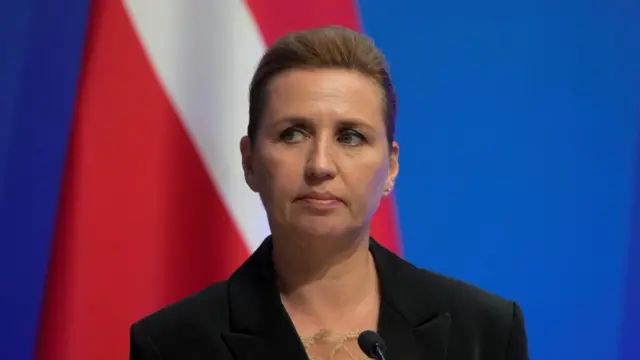 Denmark's Prime Minister Mette Frederiksen looking to her right.