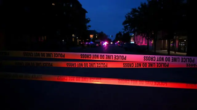Emergency police lights illuminate a tape barrier near the scene of an attack that injured multiple people, in Boulder, Colorado
