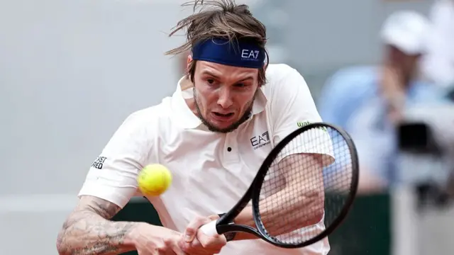 Alexander Bublik plays a backhand return