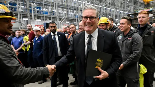 Britain's Prime Minister Keir Starmer leaves the stage after delivering a speech during a visit to the BAE Systems' Govan facility, in Glasgow, Scotland, Britain, June 2, 2025