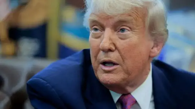 Donald Trump photographed speaking during a press briefing in the Oval Office