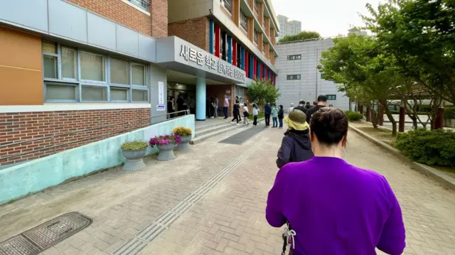 People lining up at a polling station in Paju, South Korea.