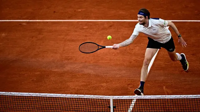 Alexander Bublik plays a forehand drop shot