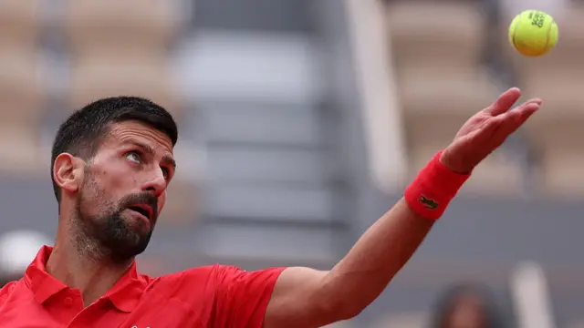 Novak Djokovic serves