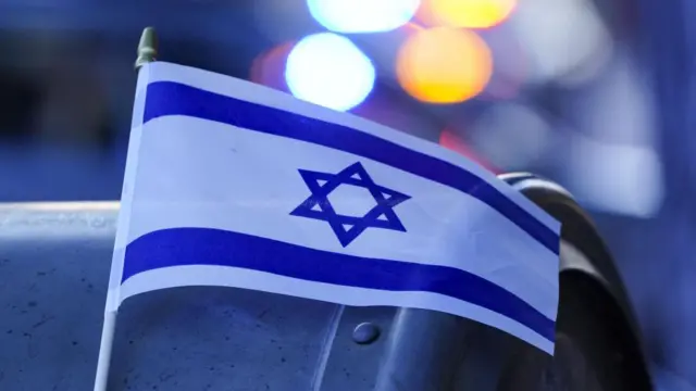 An Israeli flag hangs on a collection box near the scene of an incident in Boulder, Colorado.