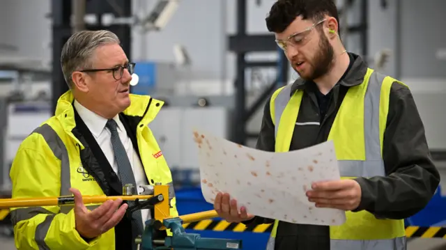 Prime Minister Sir Keir Starmer (left) speaks to a member of staff during a visit to BAE Systems in Govan, Glasgow, to launch the Strategic Defence Review