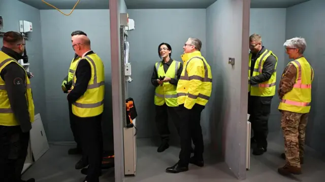 Prime Minister Sir Keir Starmer (centre) speaks to a member of staff during a visit to BAE Systems in Govan, Glasgow
