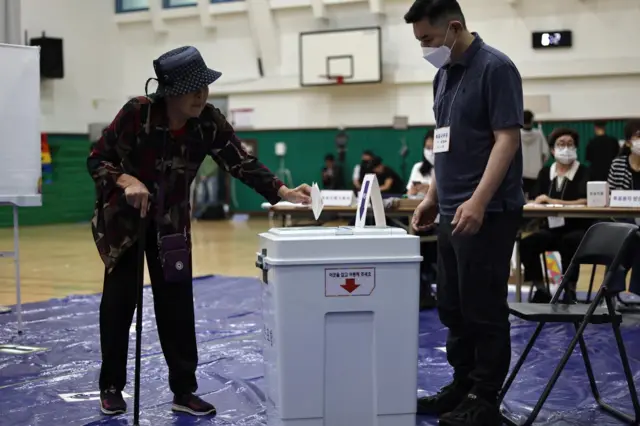 An elderly woman casts her ballot in Seoul, South Korea.