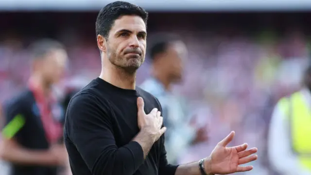Mikel Arteta, Manager of Arsenal, acknowledges the fans