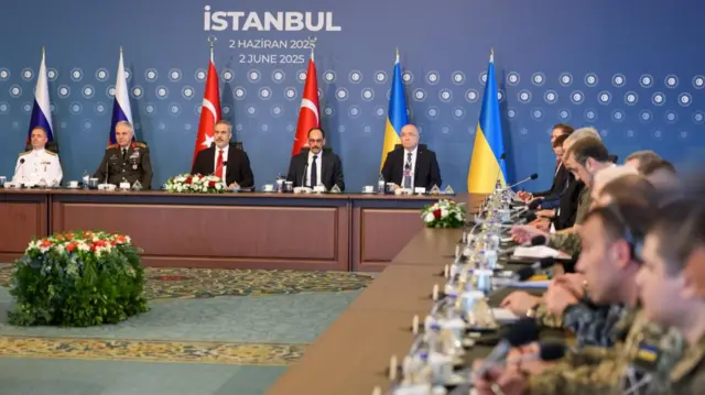 Wie shot from right side of frame of negotiations between Russia and Ukraine