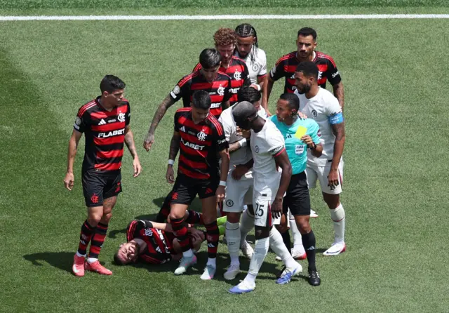 Jorginho lies on the floor as players brawl above him