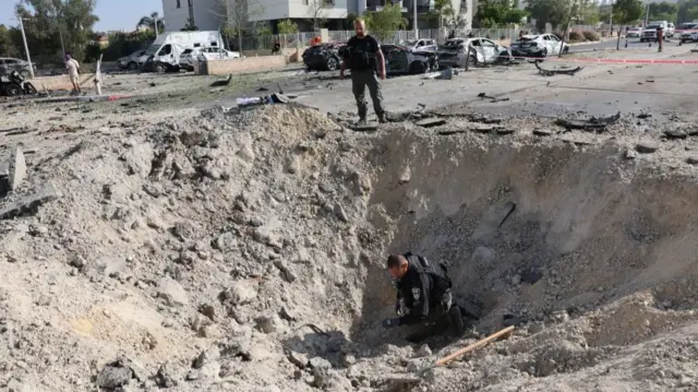 Police bomb disposal units search for remains at the site where Iranian ballistic missiles struck residential buildingsat the site where Iranian ballistic missiles struck residential buildings in Beersheva